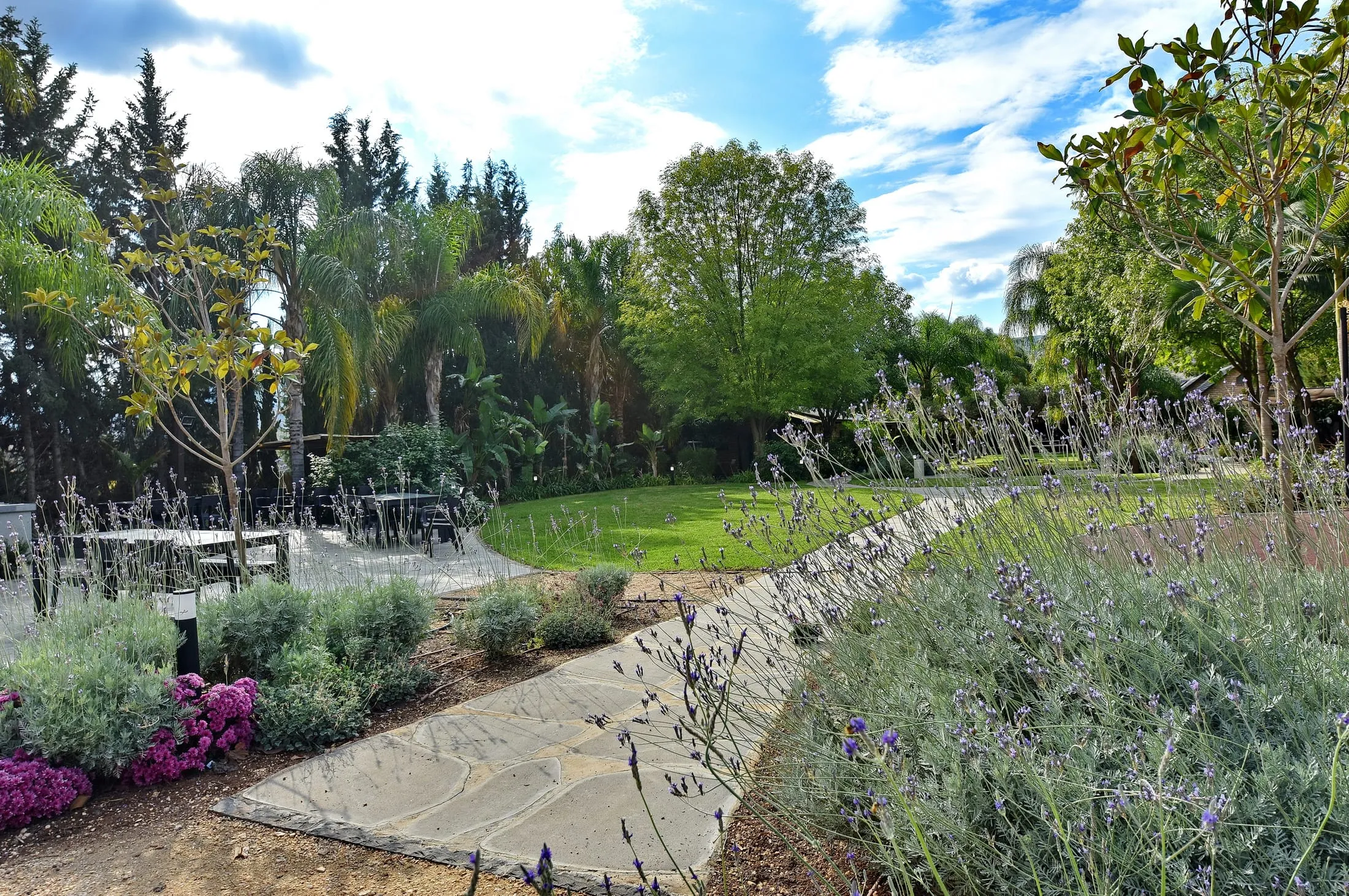Stone path through lavender and tropical gardens at Halomot Naftali resort in the Upper Galilee