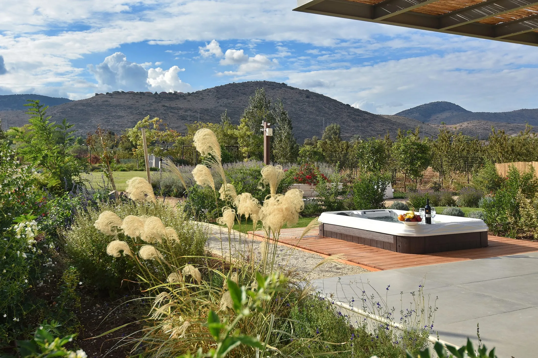 Outdoor jacuzzi on a garden deck overlooking Upper Galilee hills at Halomot Naftali resort